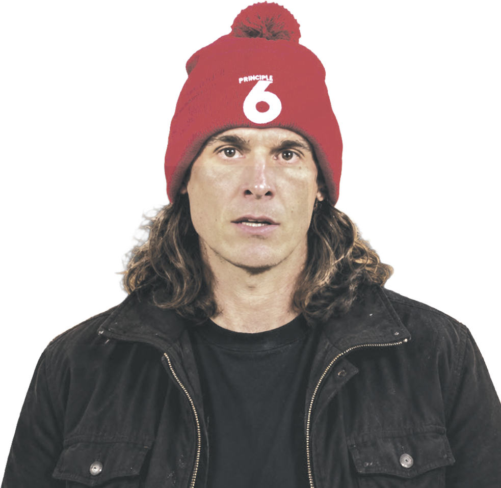 Chris Kluwe wearing a red Principle 6 beanie and a dark jacket